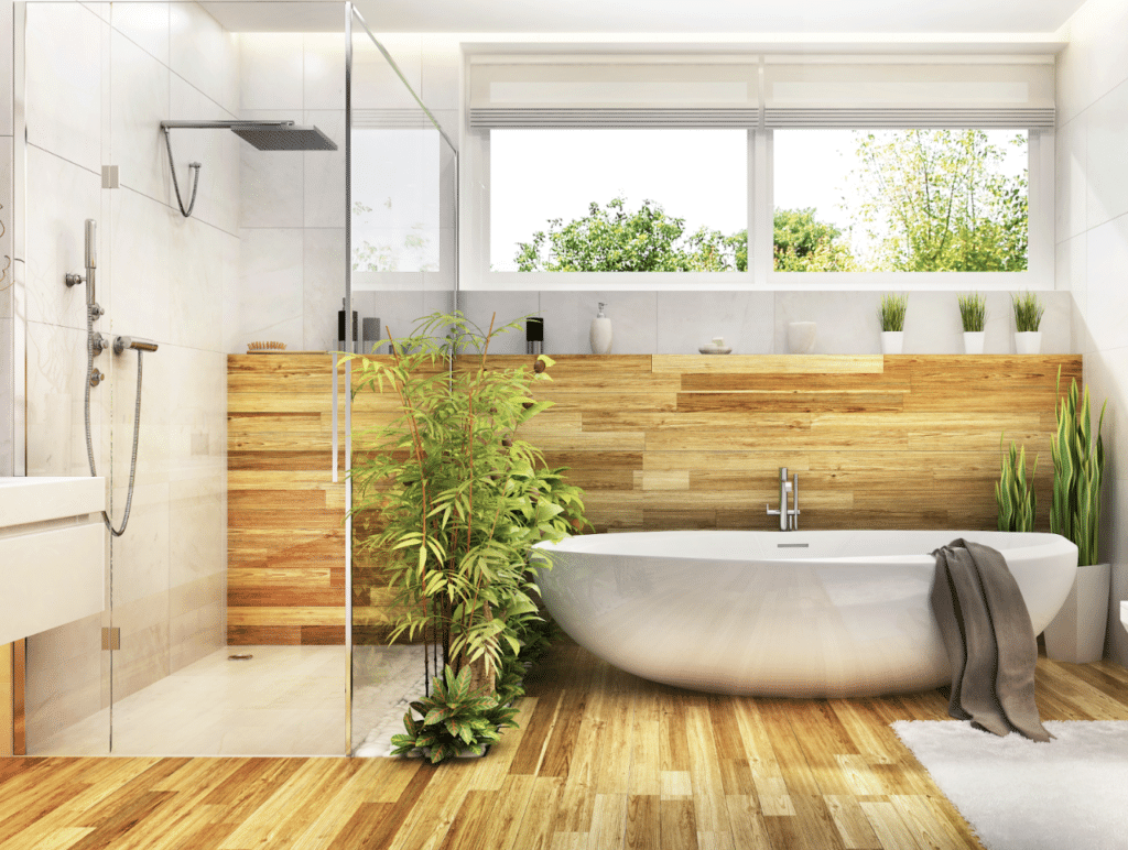 bamboo floors and half wall with freestanding bathtub and glass shower. Lots of plants. Spa Like Bathroom